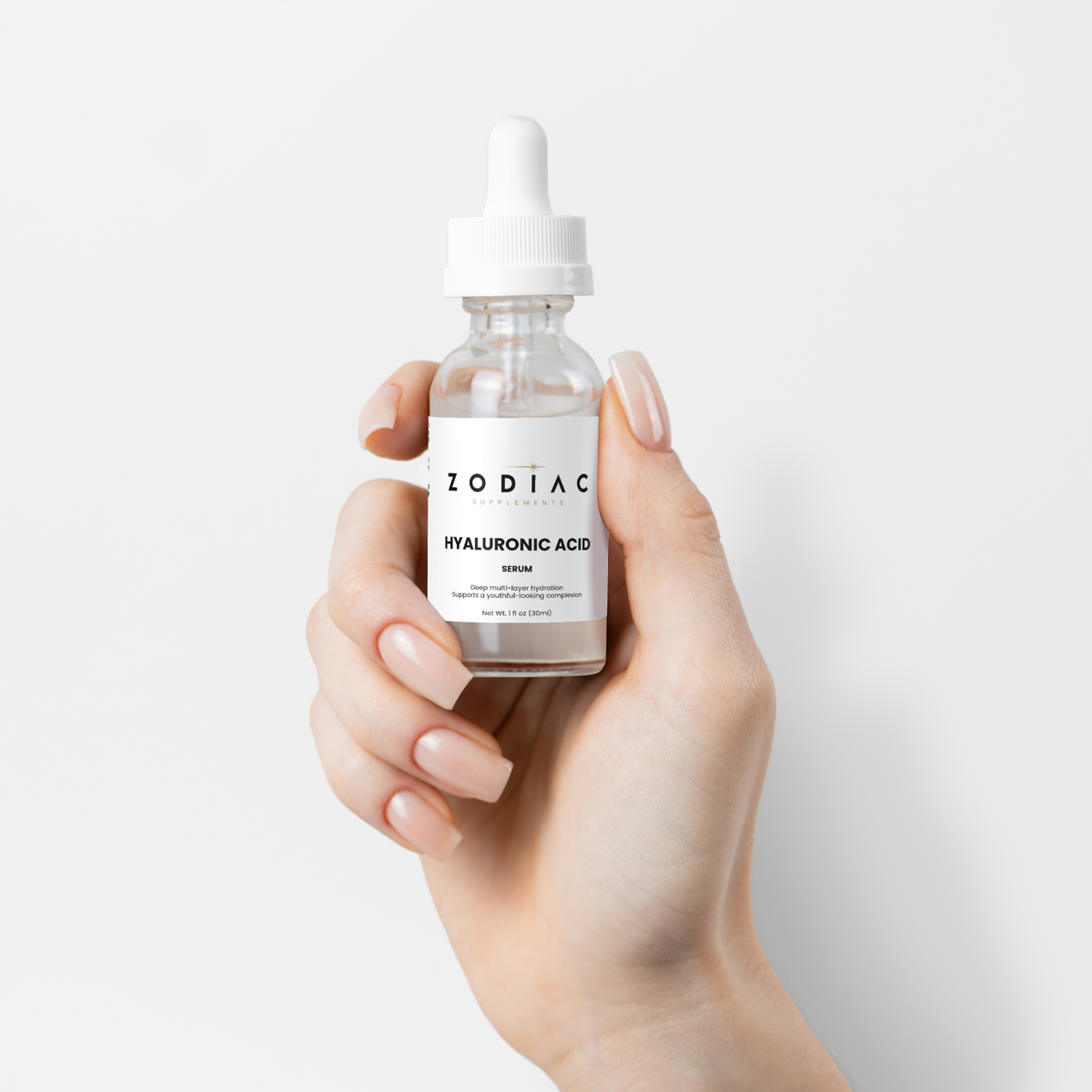Hyaluronic Acid Serum in a dropper bottle held in a hand, showcasing its skincare benefits.