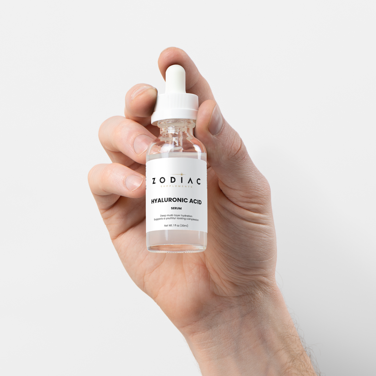 Hyaluronic Acid Serum bottle held in hand, showcasing its hydrating skincare benefits.