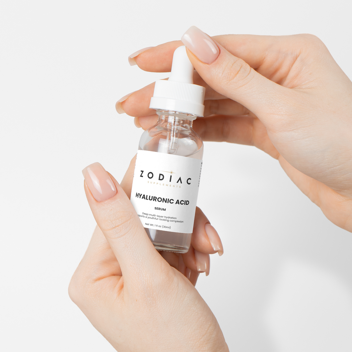 Hands holding a bottle of Hyaluronic Acid Serum, highlighting its moisturizing properties.