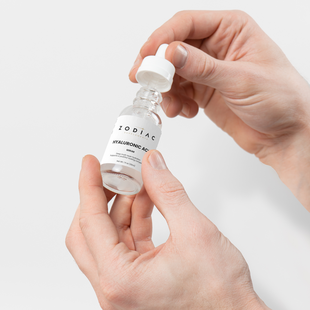 Hand holding a bottle of Hyaluronic Acid Serum, designed for hydration and skin rejuvenation.